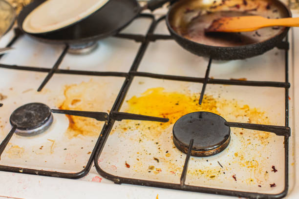 Applying baking soda paste to a burnt stainless steel pot to remove stains