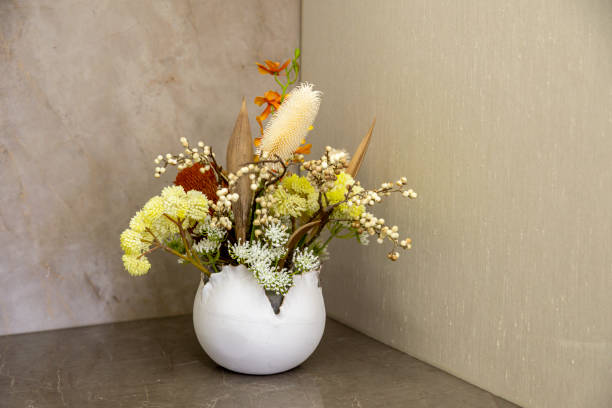 Subtle moss lining the base of a vase to complement the silk flower display