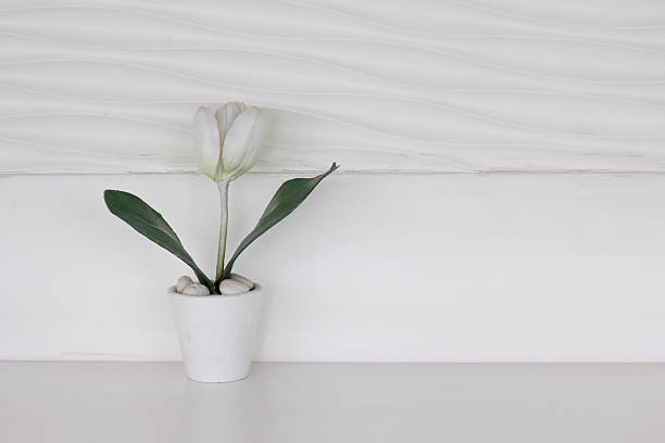 Layer of white sand in vase base enhancing the beauty of artificial blooms